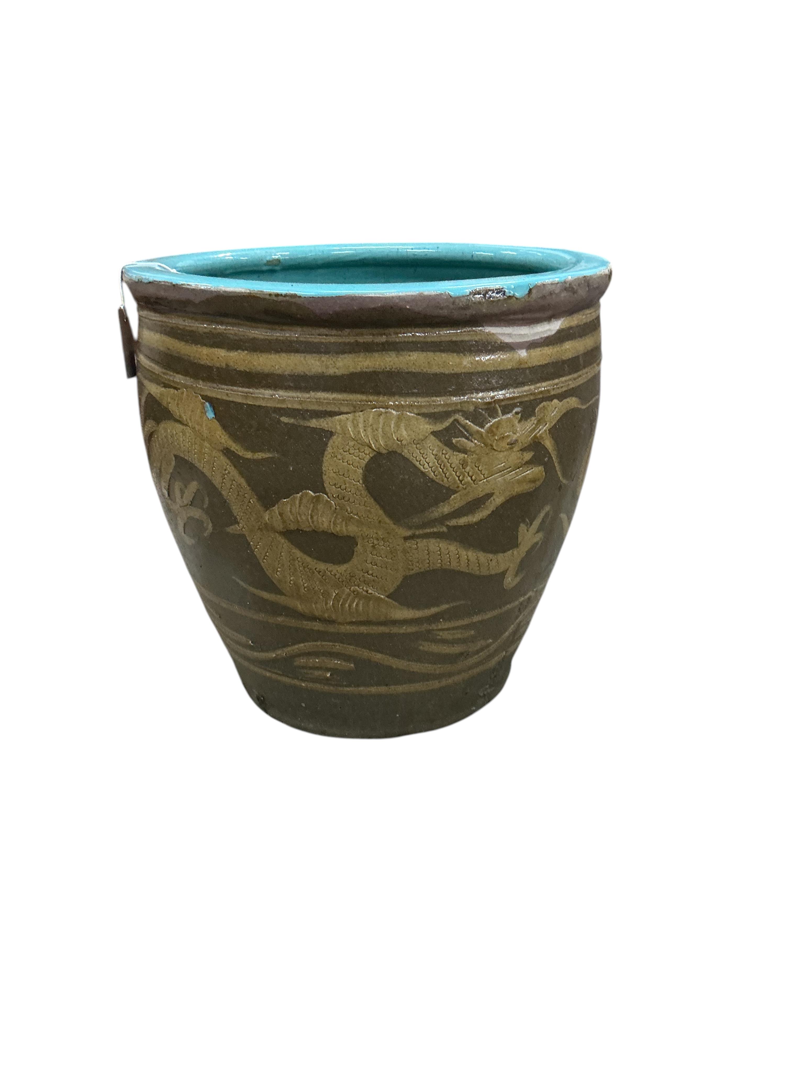 A large glazed earthenware Chinese style planter, diameter 50cm, height 48cm